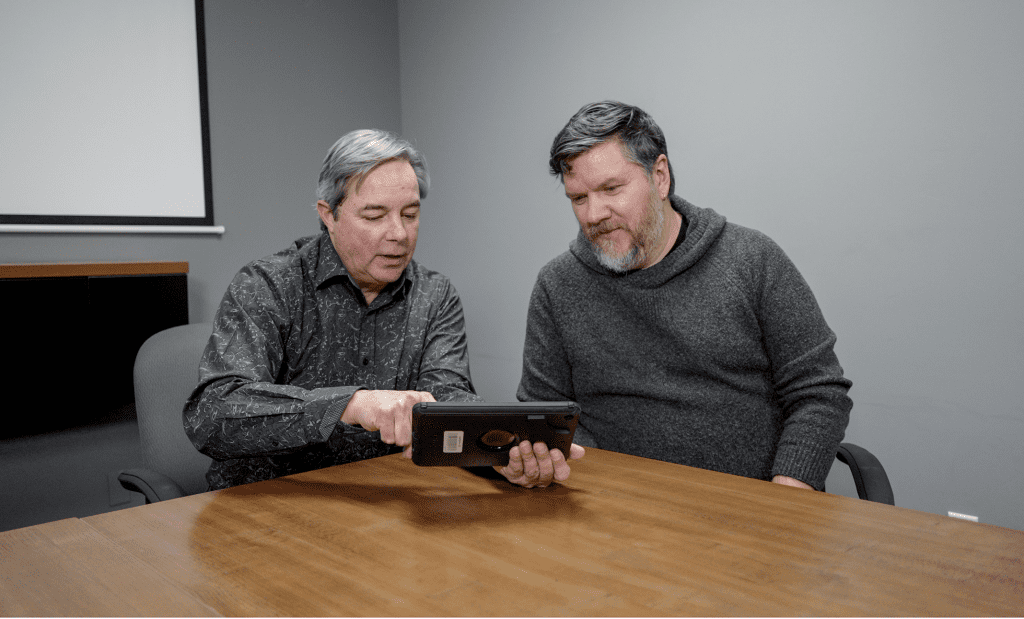 Customer experience lead Brad Plumton is reviewing the software and pathfinder images with a client.
